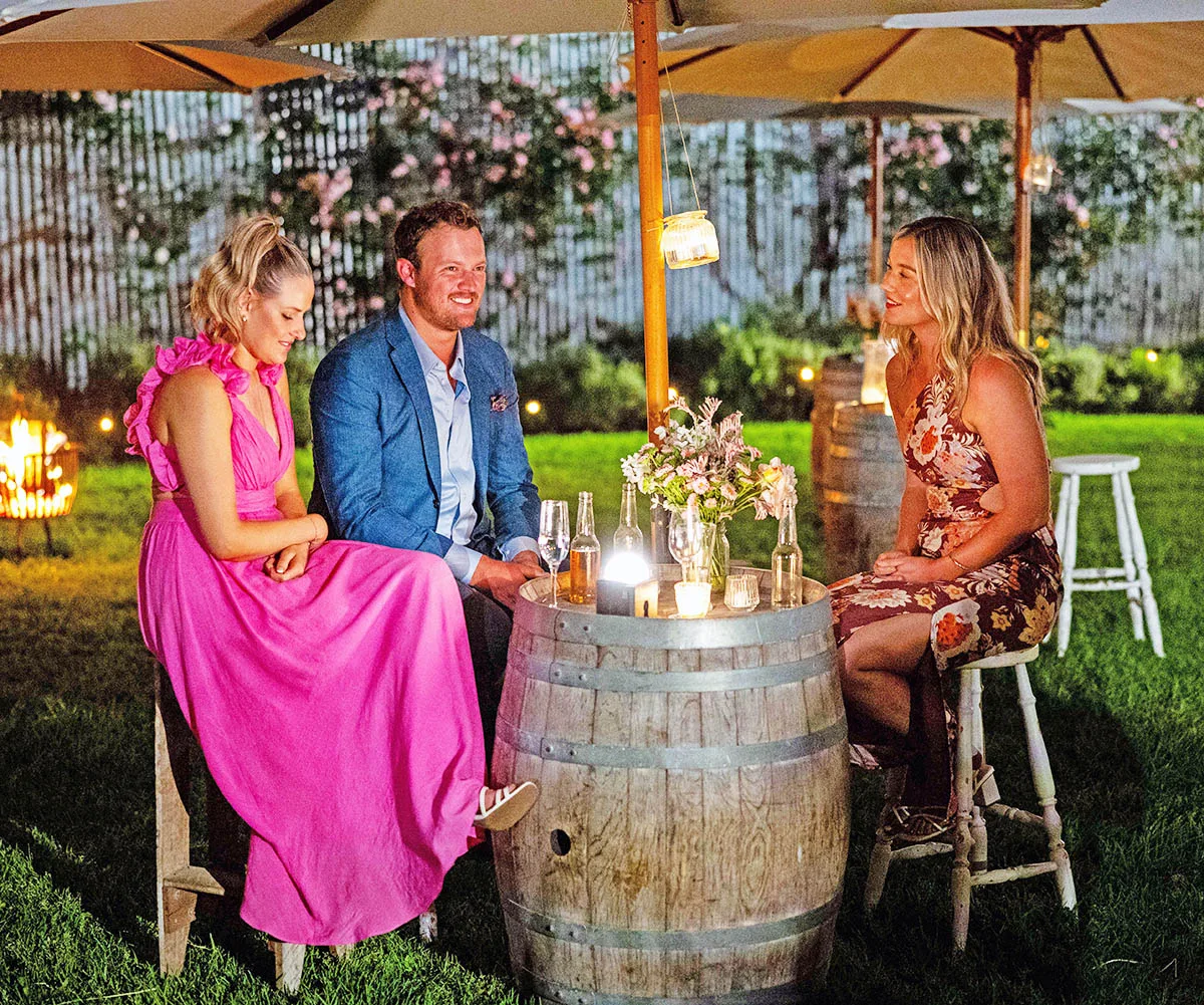 Keeley, Corey and Chloe sit around an outside table at the country ball