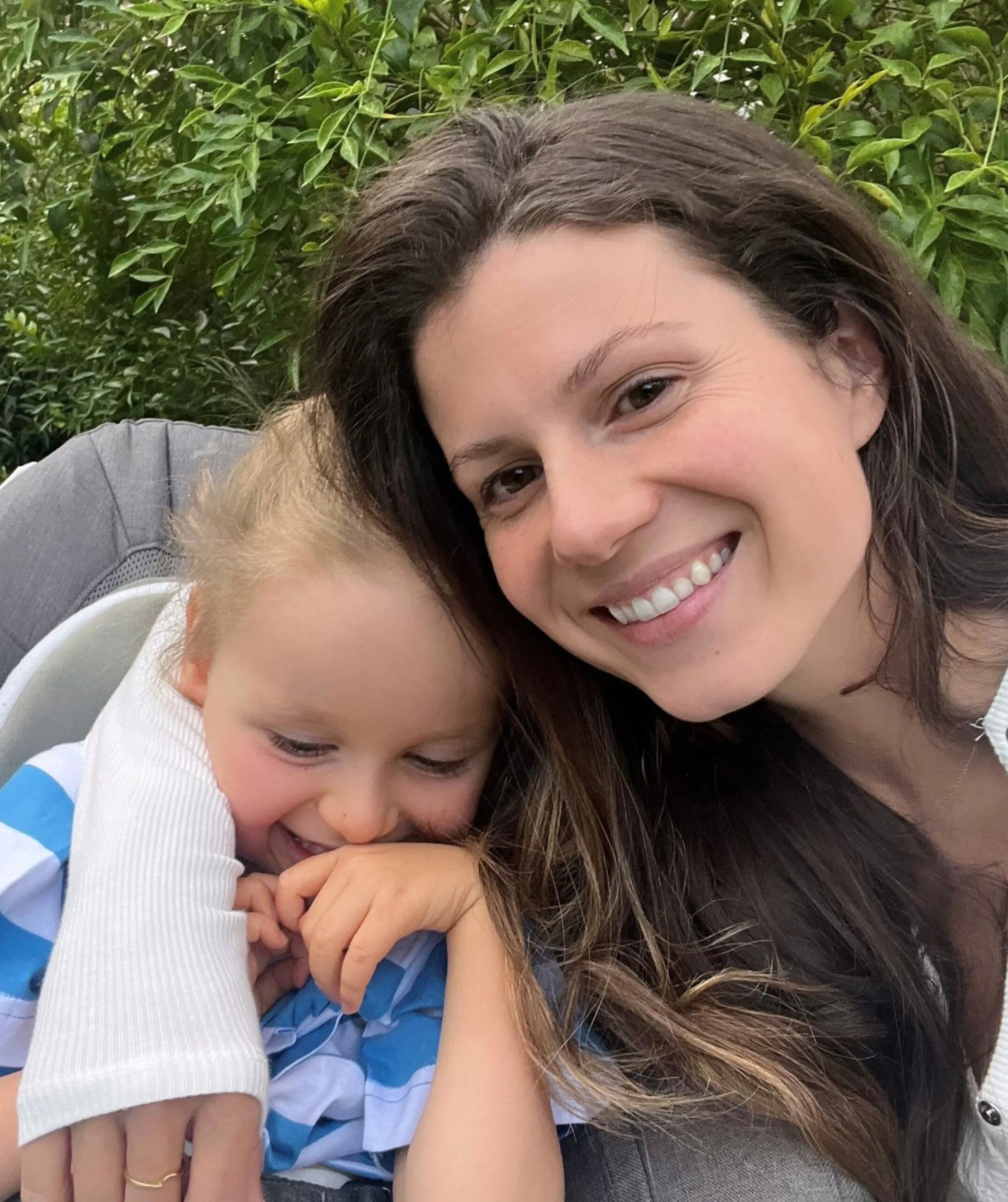 A woman and a little boy laughing.