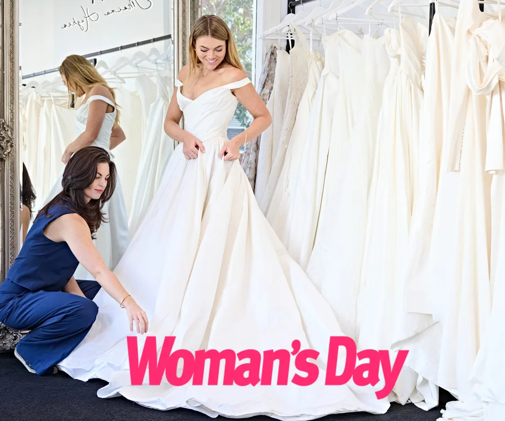 Designer Moira Rose fluffs up one of Jacqui's gowns.