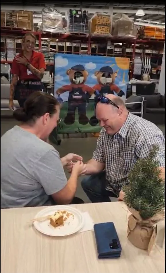 Jeff presenting Melanie with a ring in Bunnings