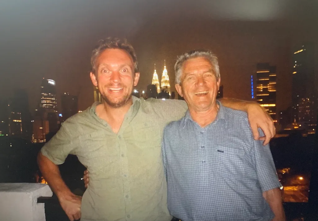 Jon Beardmore with his arm around his dad when they were in Malaysia