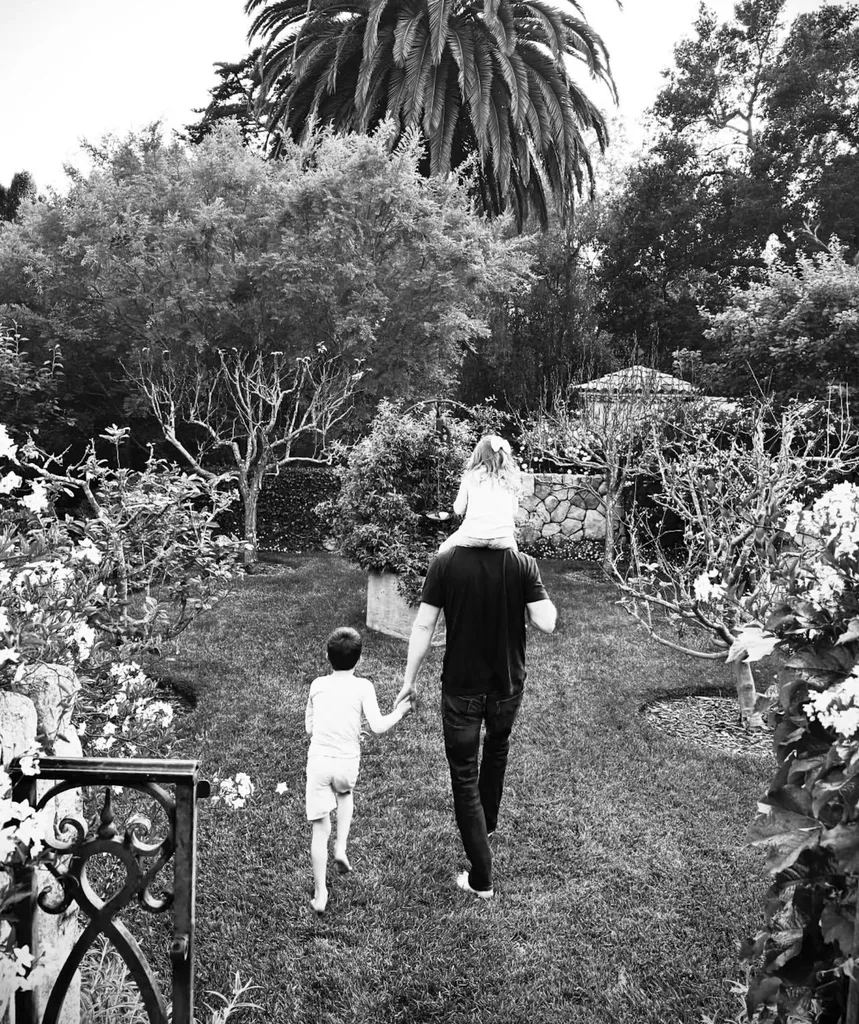 A black and white shot of Harry with his two children