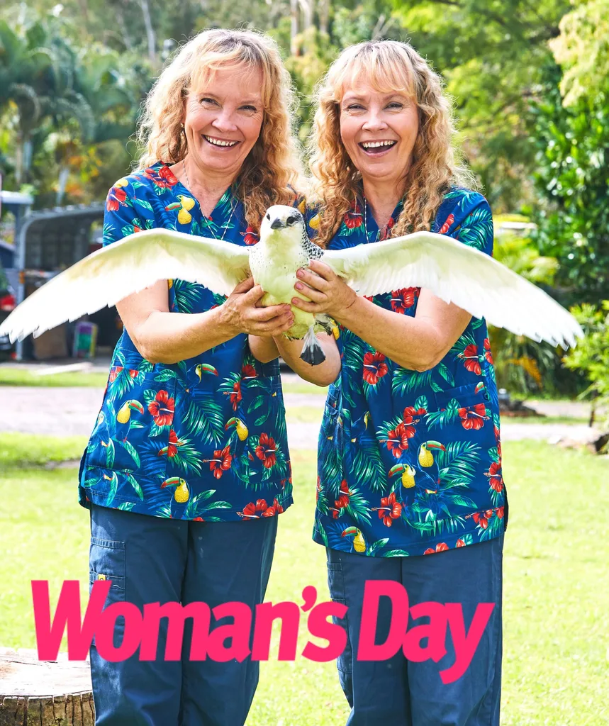 The Twinnies stand with a red tail tropicbird