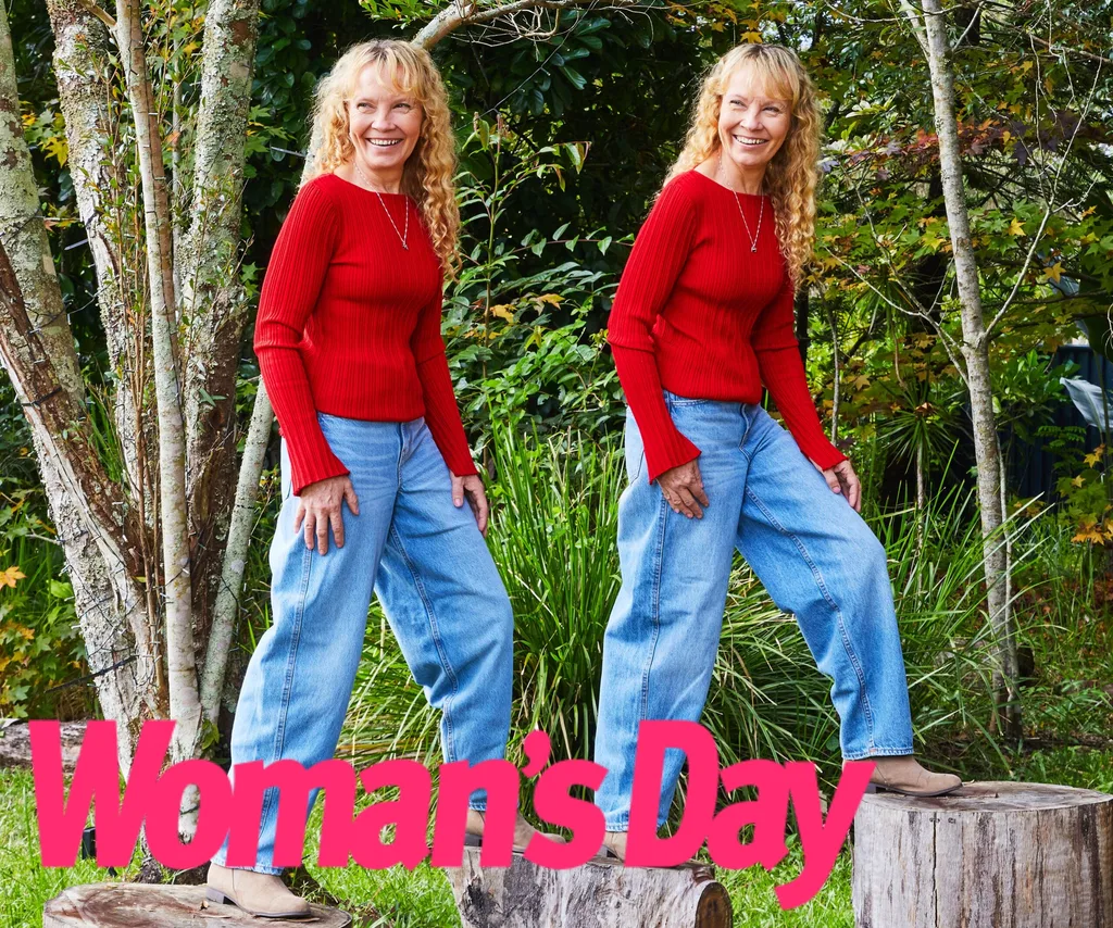 The twins stand in matching red tops and blue jeans as they stand on tree logs.