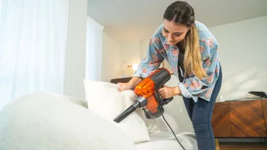 Woman vacuuming couch