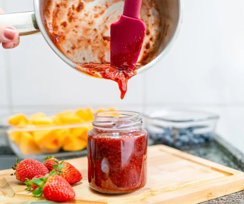 jam being poured into a jar