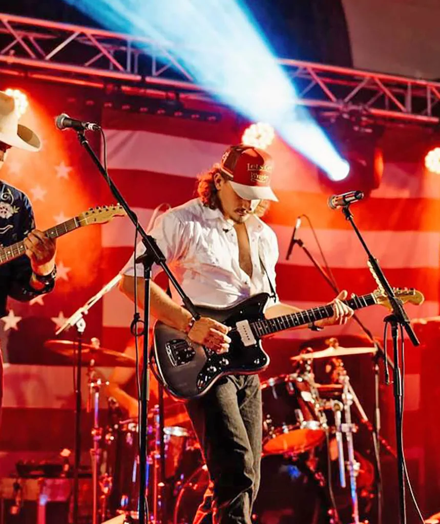 Jarrad playing guitar on stage.