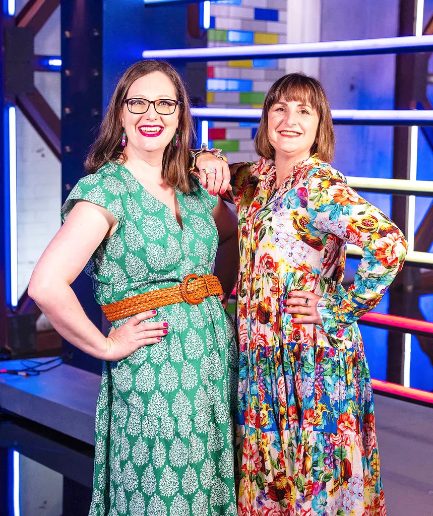 On left: Emily smiling ith hand on hip in a green dress, brown belt, glasses and medium length brown hair.
On right: Sarah with short brown hair and a fringe smiling in a brighly colourful long sleeve and full length dress on LM set