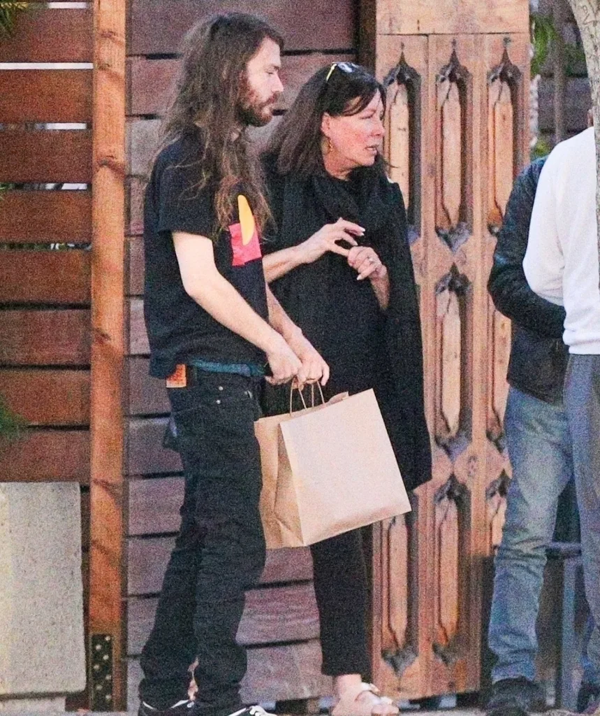 A man and woman stand on the street.