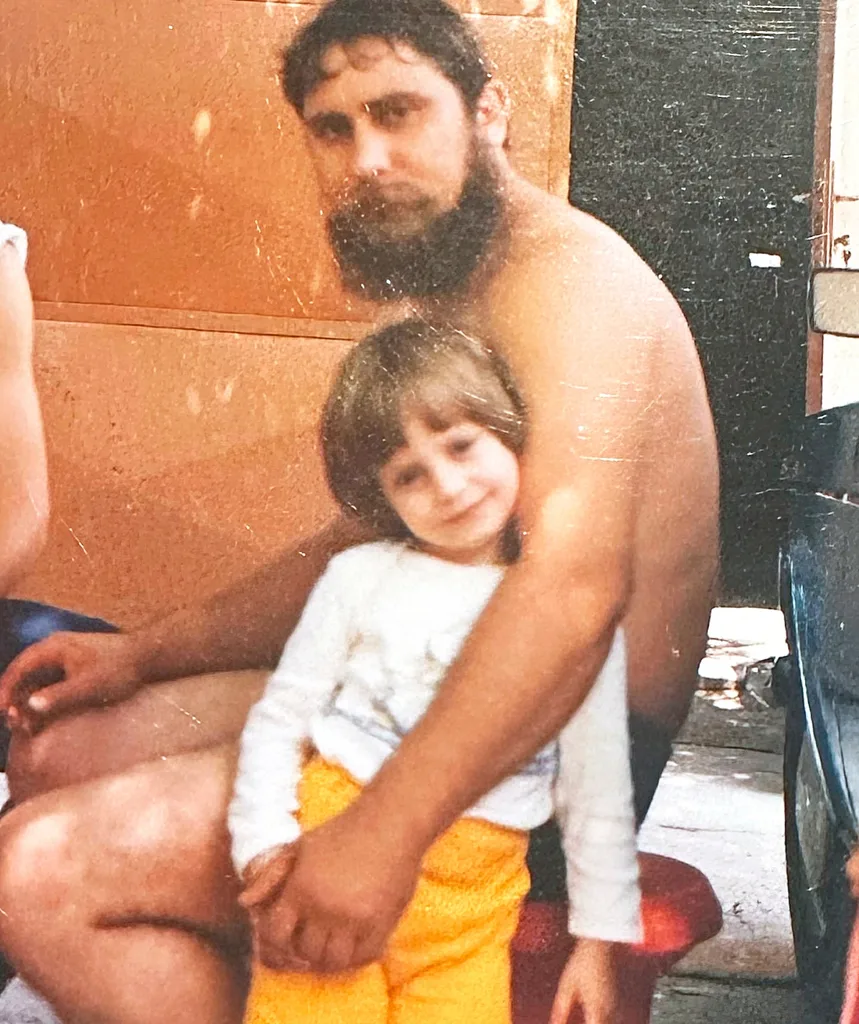 Jelena as a young tot is cuddled by her father.