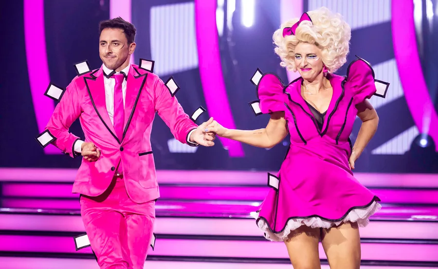 Felicity Ward and dance partner Aric Yegudkin, both dressed in hot pink, dance on the set of Dancing With The Stars.