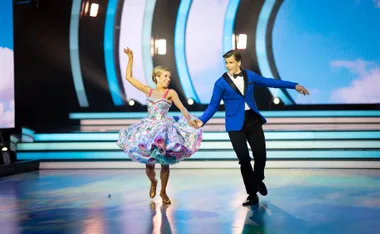 Osher and his dance partner Sriani Argaet hold hands as they dance the foxtrot on the set of Dancing With The Stars.