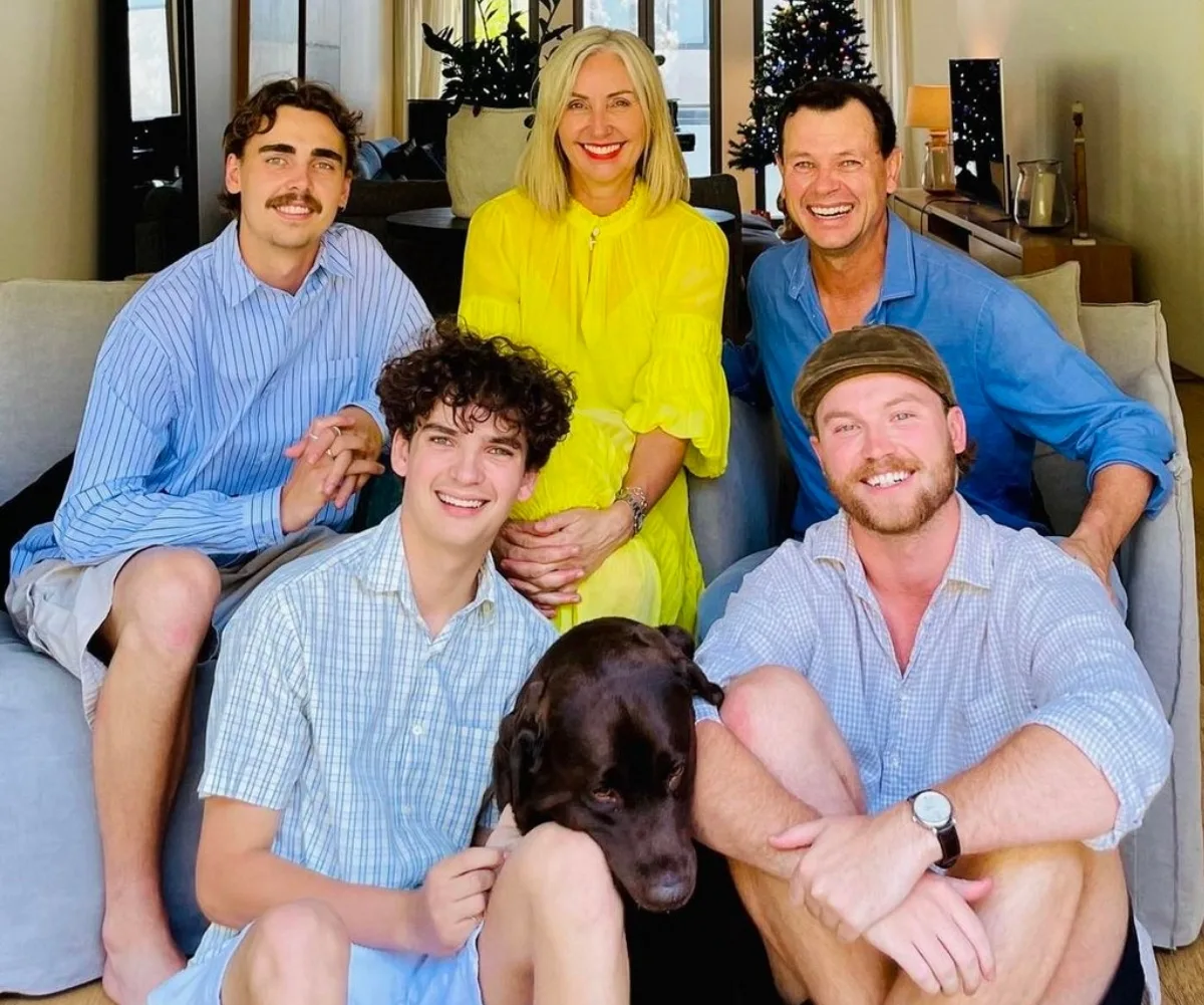 Jane and Mark pose with their three sons.