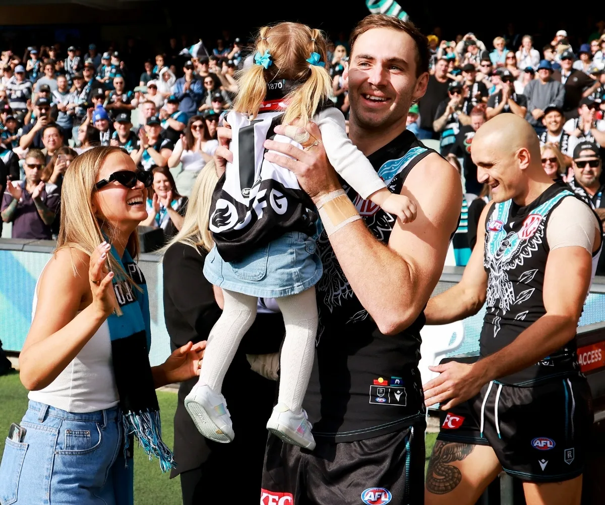 Kellie and Sophie support Jeremy at one of his AFL games