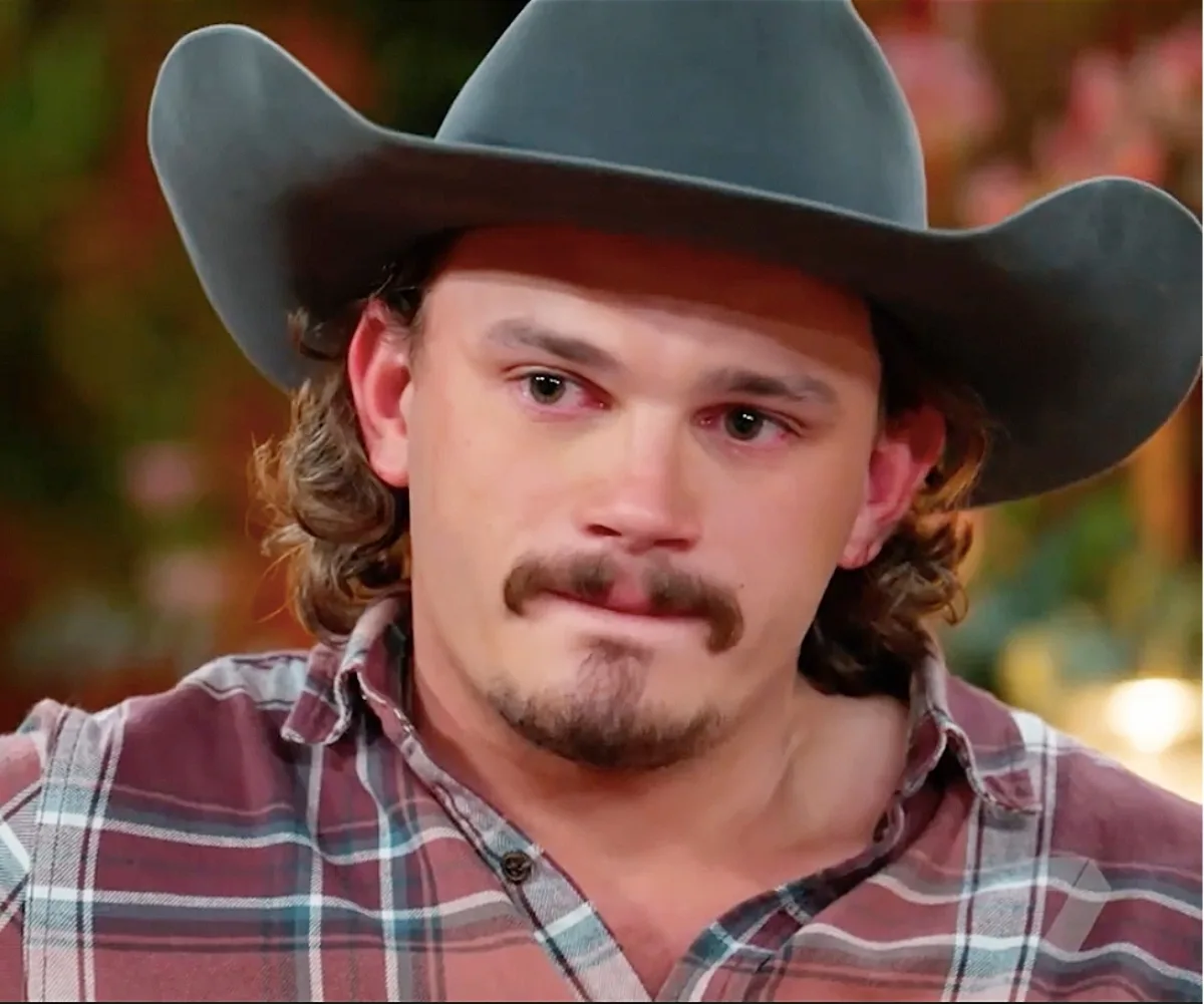 Farmer Jarrad sits on the couch looking teary.