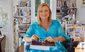 Carol Taylor wearing one of her own designs, ;Oceania’ is the name of the painting, printed on 100% silk. (Image: Supplied)