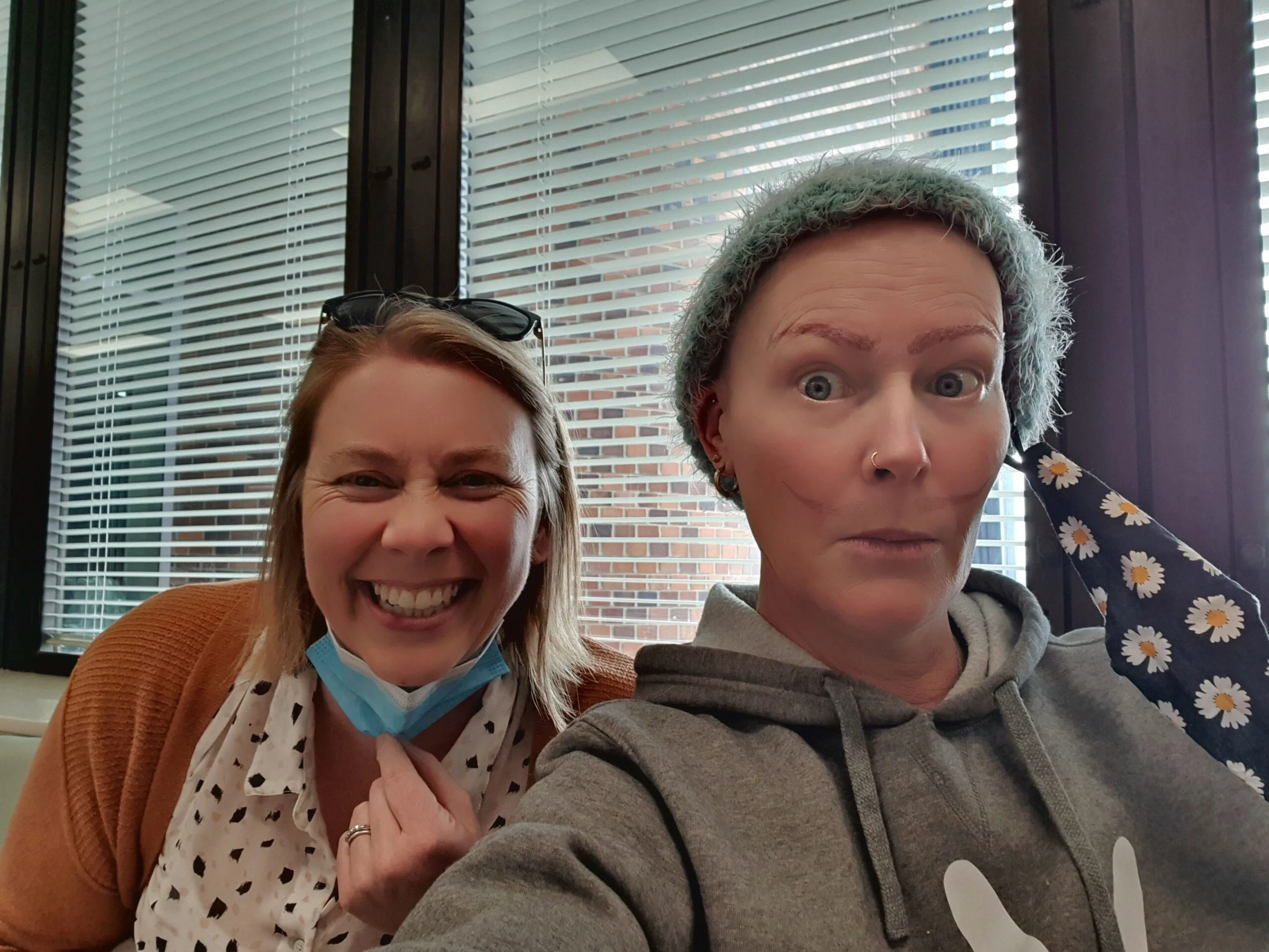 Me and my friend Kate while I was getting chemo and showing my fake eyebrows above my lips. (Image: Supplied)