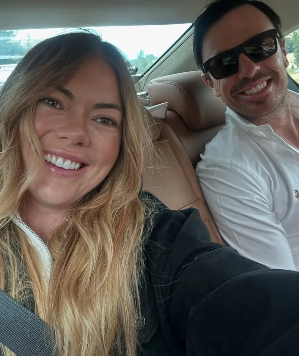 Jacqui and Clint pose in the back of a car