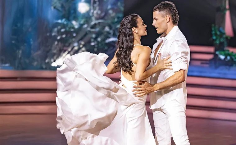 Harry and Siobhan on the state dance together. Both wear white, her dress is flowing as Harry embraces her and looks into her eyes.