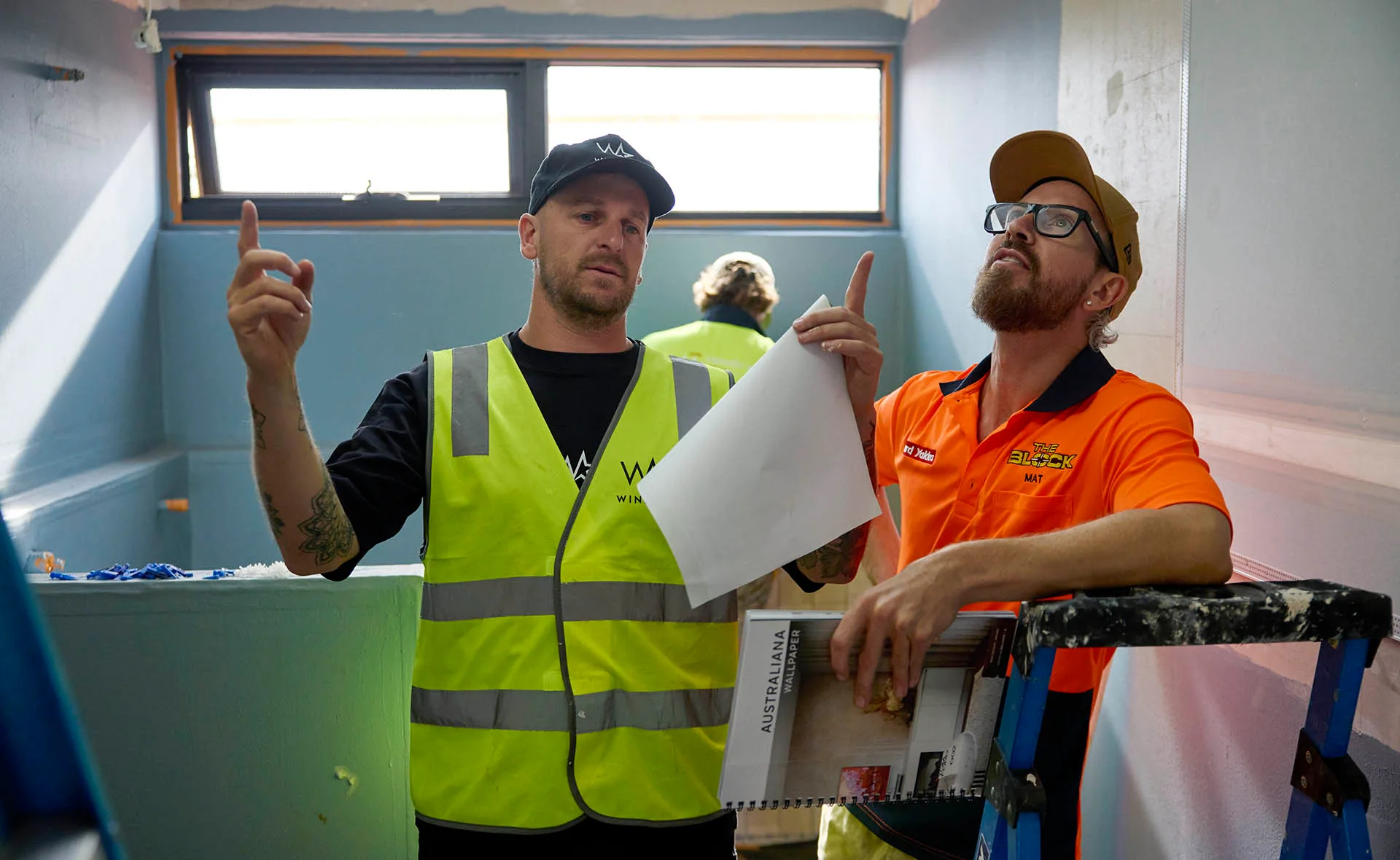Robby and Mat wearing hi vis standing in their Master Ensuite looking at the roof on The Block.