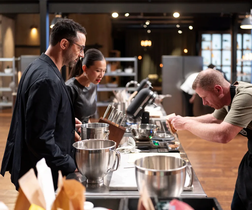 Poh and fellow judge Andy Allen check out a contestant's cooking in the MasterChef kitchn