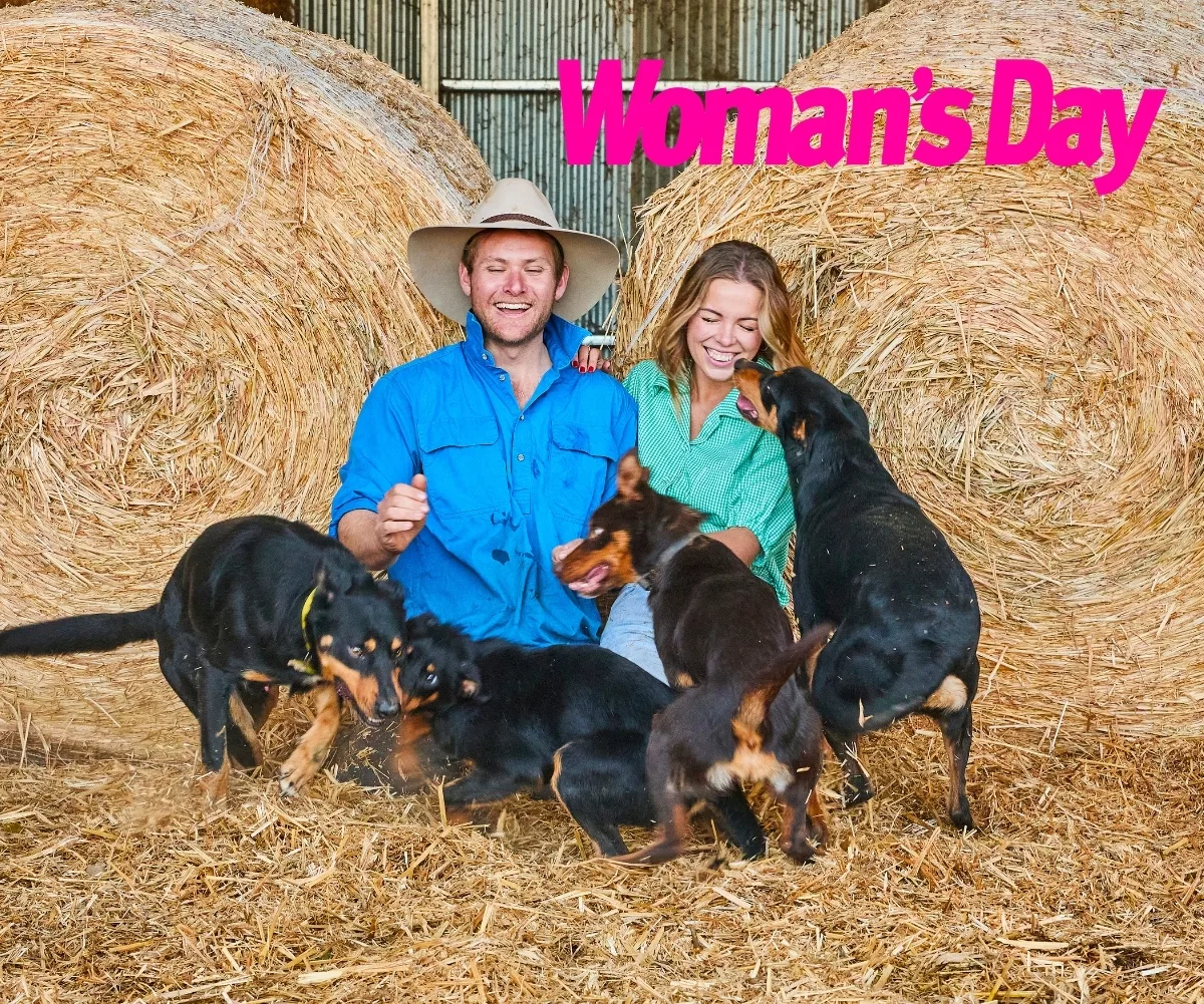 Tom and Goergie pose with their dogs amongst the hay
