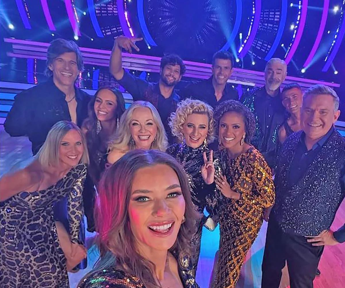 The entire DWTS 2025 cast pose for a selfie on set.