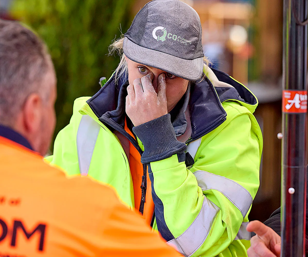 Han cries into her hand while wearing a hi-vis jacket and hat on The Block 2025.
