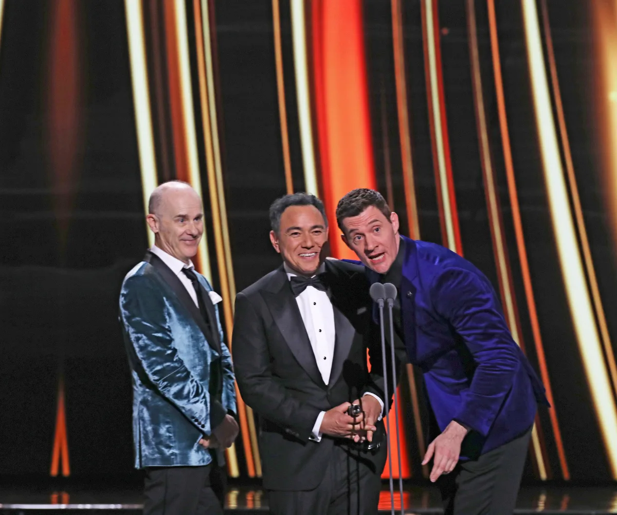 Sam with his co-stars on the Logies stage to present an award. Sam in a tuxedo and the others in blue blazers and suits.