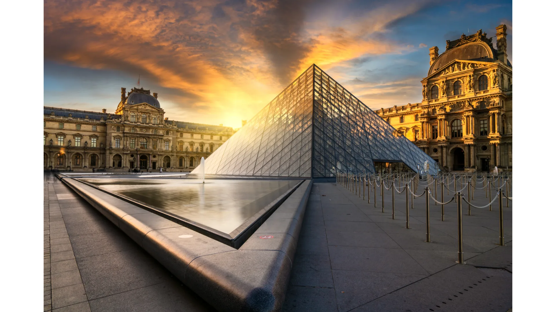 The sun rises over the Louvre.