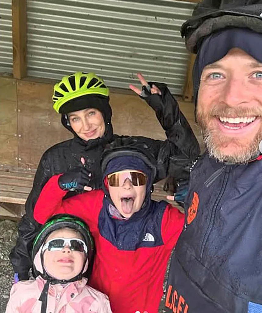 Zoe does the peace sign as she, Hamish and their two kids, Rudy and Sonny pose for a selfie with helmets on.
