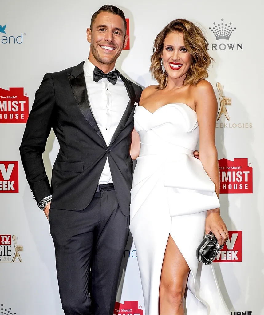 Lee Elliot and Georgia Love stand next to each other on a red carpet