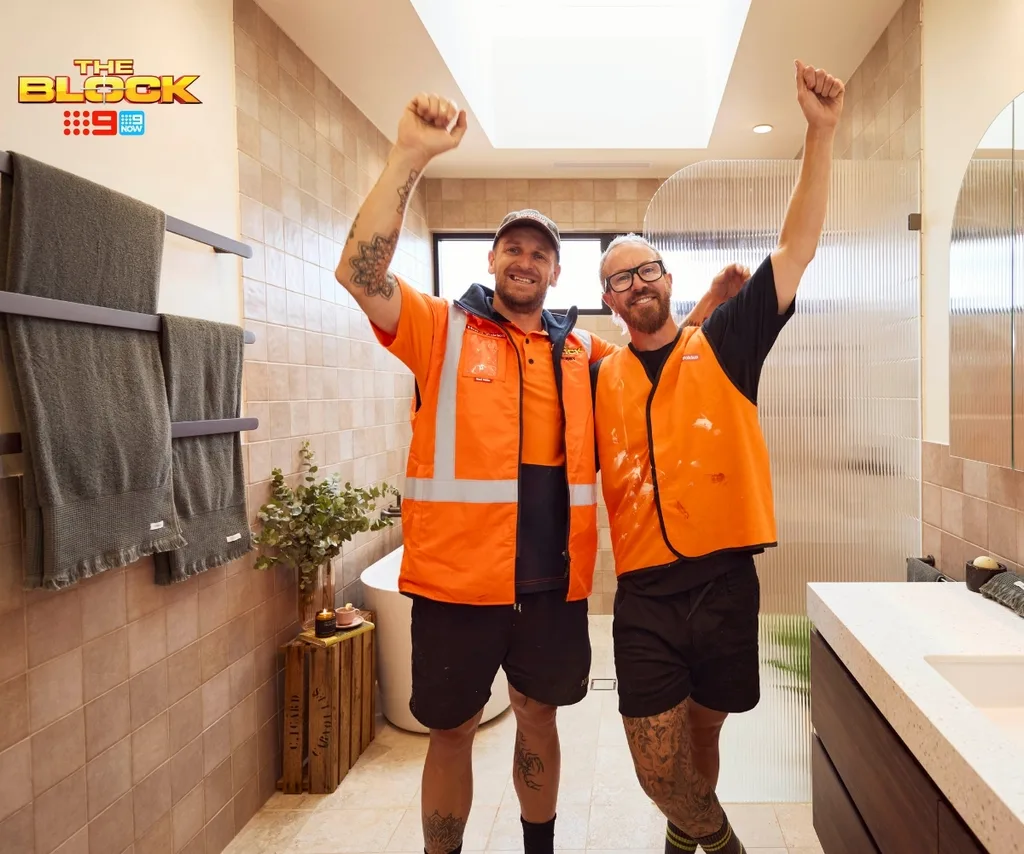 Robby and Mat stand in their first bathroom