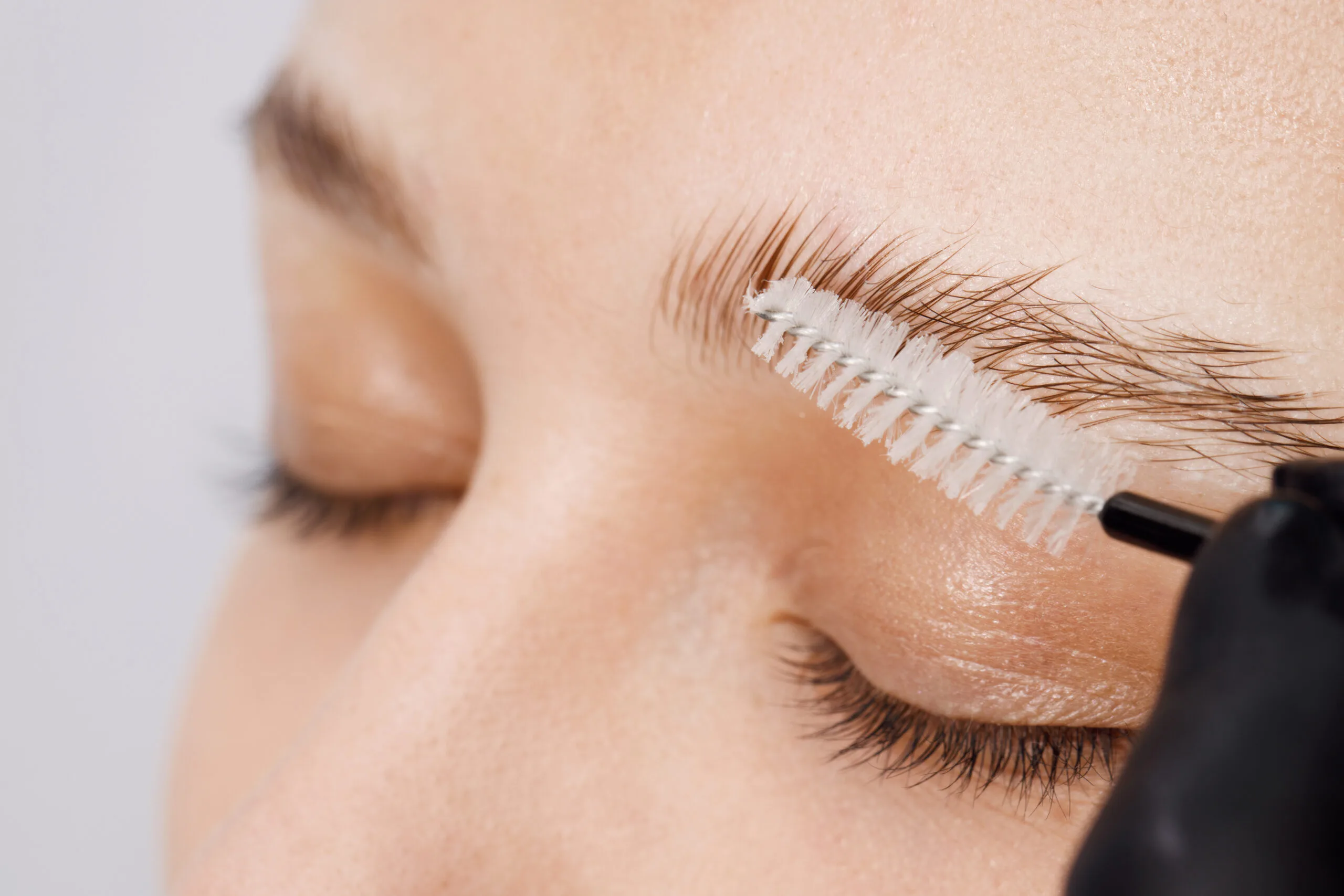 makeup artist brushing eyebrows