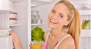 Woman standing in front of organised fridge