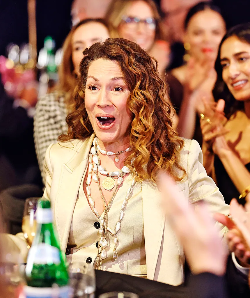 Sitting at a table at the Logies, Kitty Flanagan has a shocked but delighted look on her face.
