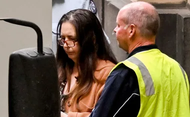 Erin Patterson being escorted from the court room to a car after being sentenced to 33 years prison time for the murder of three, and attempted murder of one.