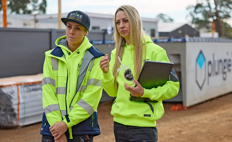 Han and Can in yellow hi-vis on site on The Block looking stressed.