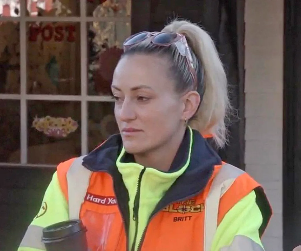 Britt looking unhappy while holding a coffee on set of The Block 2025.