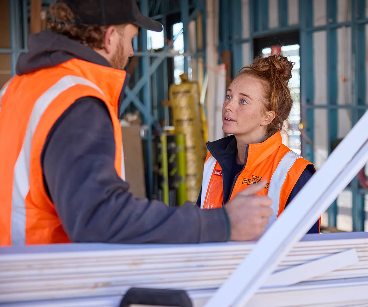 Emma and Ben in hi-vis looking sad on site on The Block.