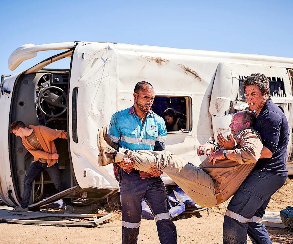 Pete (Stephen Peacocke) pulls a bus driver to safety in season 3 of RFDS.