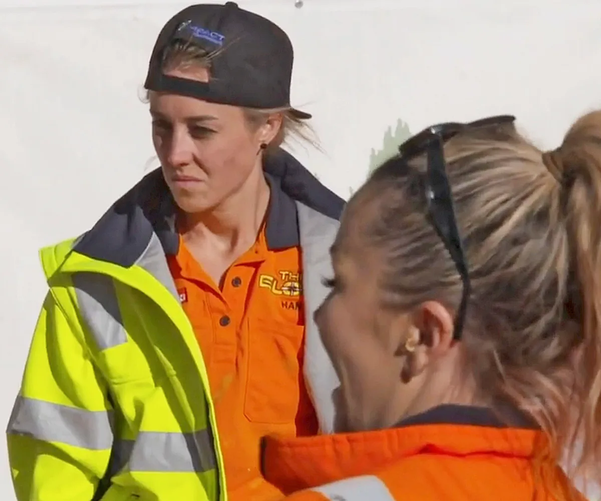 Han looking frustrated while Alicia laughs at a body corporate meeting on The Block.