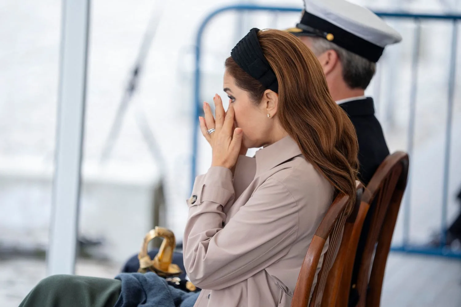 Queen Mary appears to wipe her eye as she watches commemorations for National Flag Day