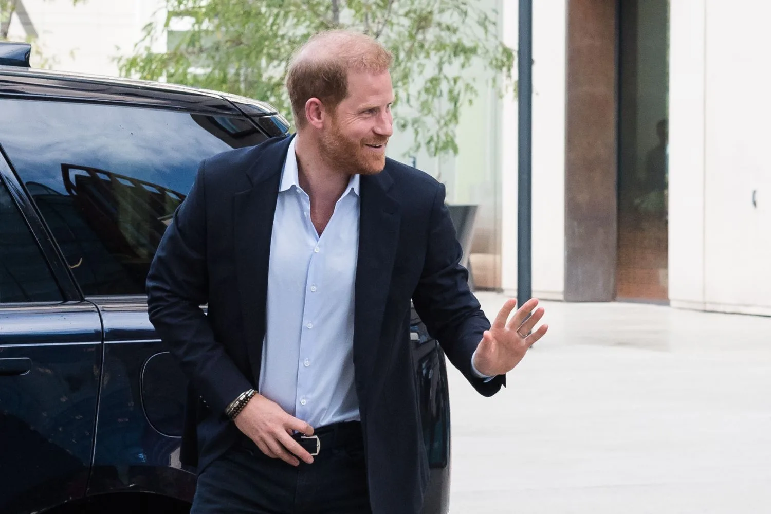 Prince Harry waves during a visit to the UK