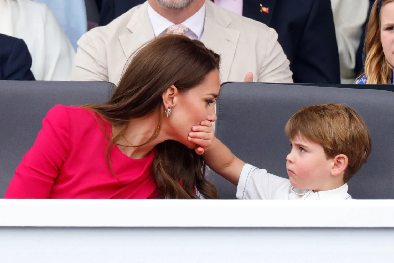 Prince Louis places his hand over his mother Kate Middleton's mouth during a public appearance