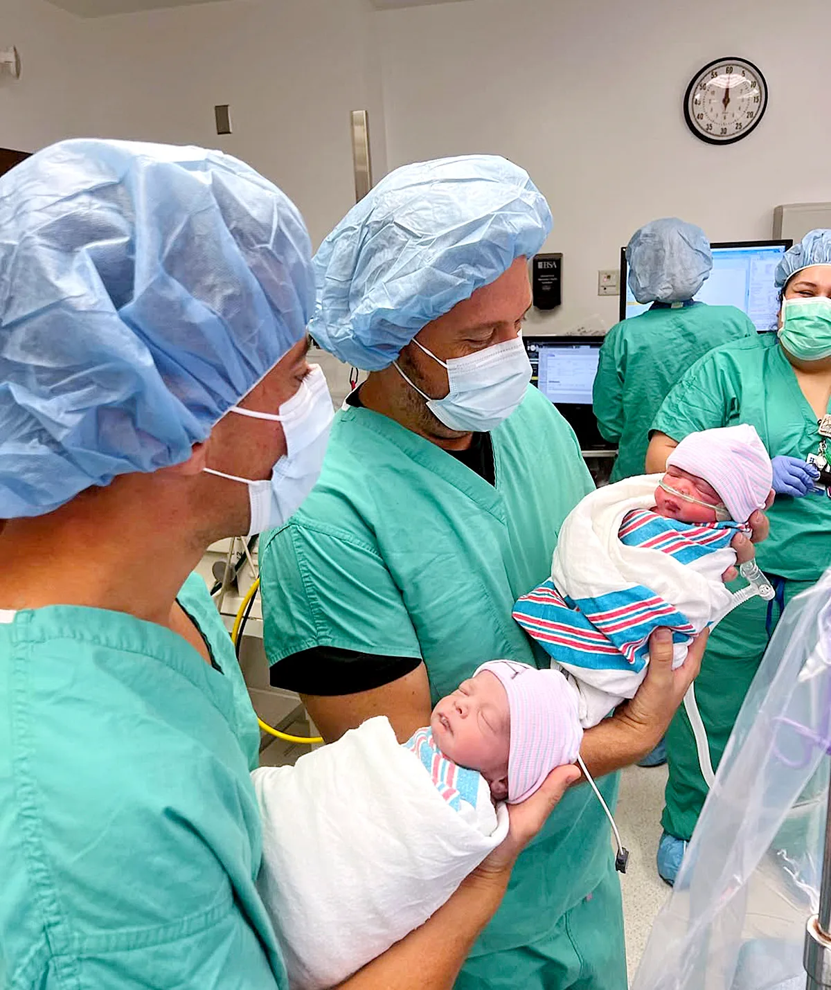 'Sassy' Scott with husband Marcus in the delivery room after their twin sons were born via surrogacy in Feb 2024.