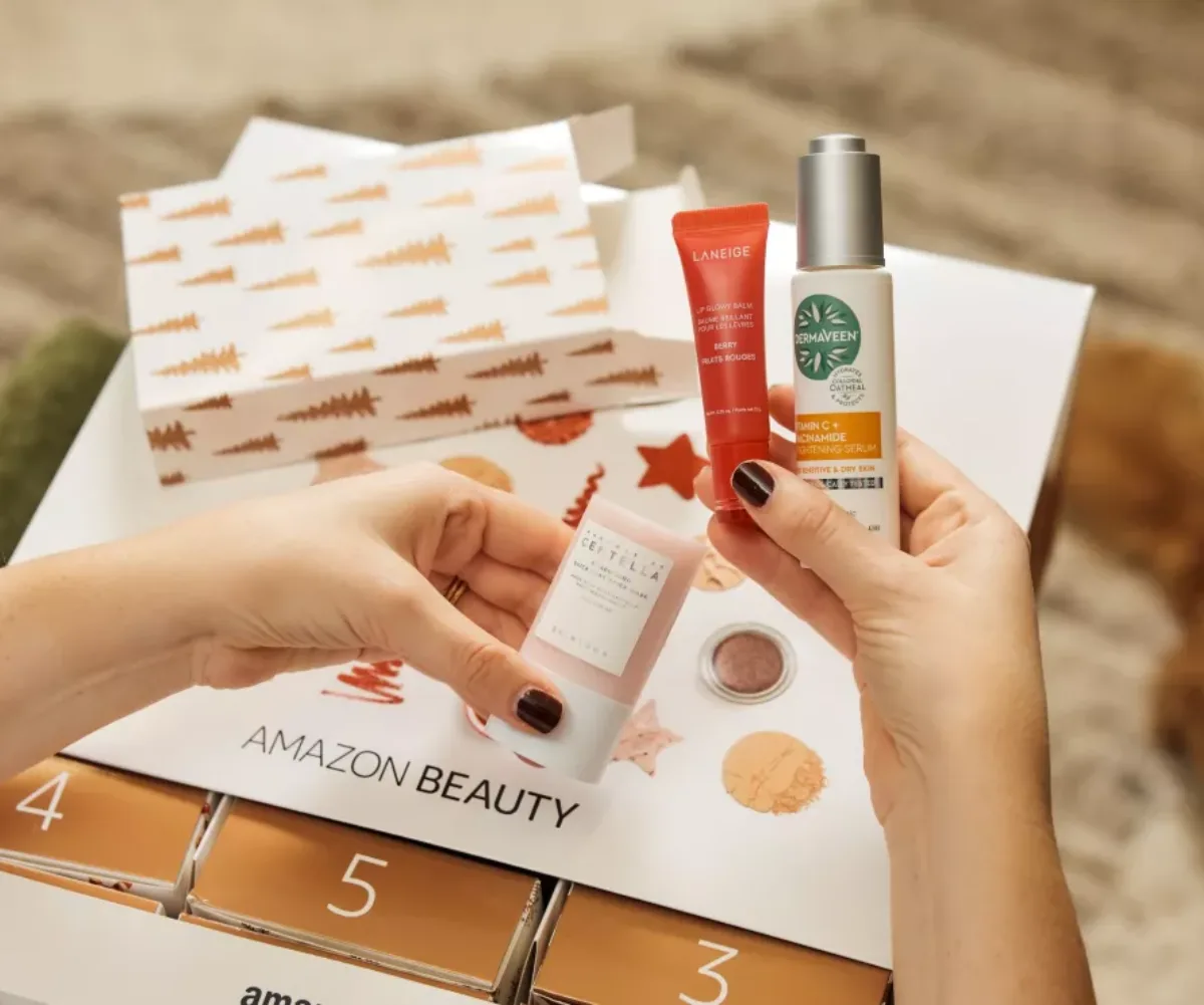 woman's hands looking at beauty products in Amazon Advent Calendar. 