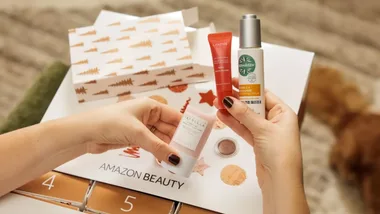 woman's hands looking at beauty products in Amazon Advent Calendar.