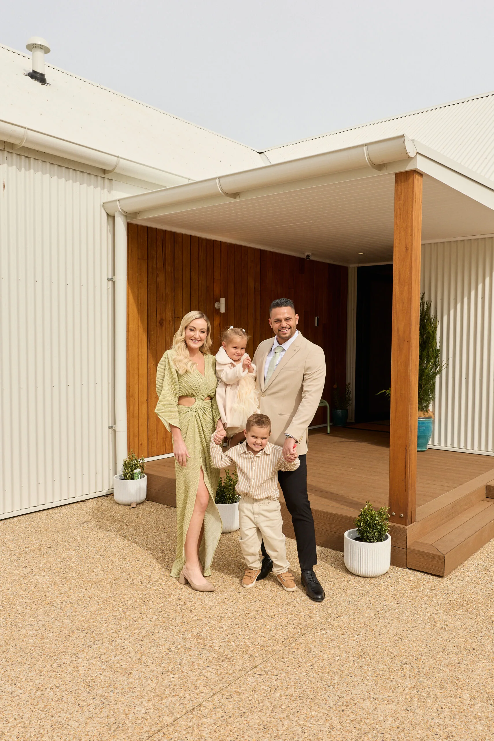Britt and Taz with their two children out the front of their winning house, House 3, on The Block 2025.