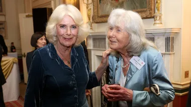 Queen Camilla and Jilly Cooper pose during a reception to mark the launch of the Queen's reading room medal at Clarence House on March 25, 2025 in London, England. Queen Camilla, accompanied by King Charles III, The Duchess of Gloucester, and distinguished authors along with members of the literary community, came together to celebrate the continued efforts of The Queen's Reading Room and its mission to inspire greater reading among people.
